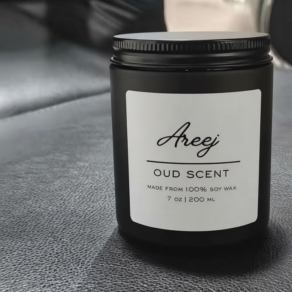 Black candle jar with 'Areej' label on a textured surface